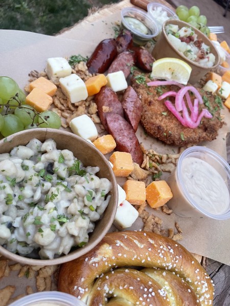 Duck Haus feast board with pretzel and schnitzel